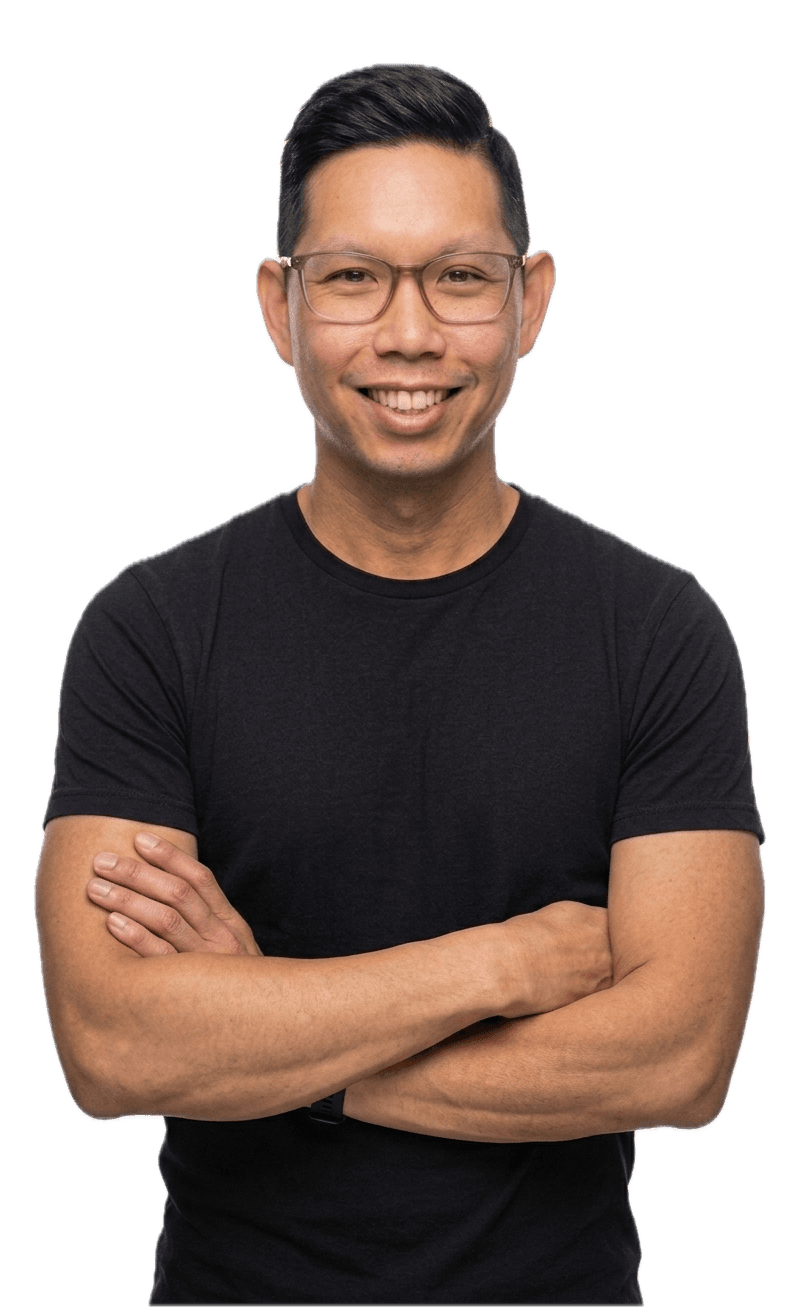 Portrait of Kevan Lin smiling with arms crossed.